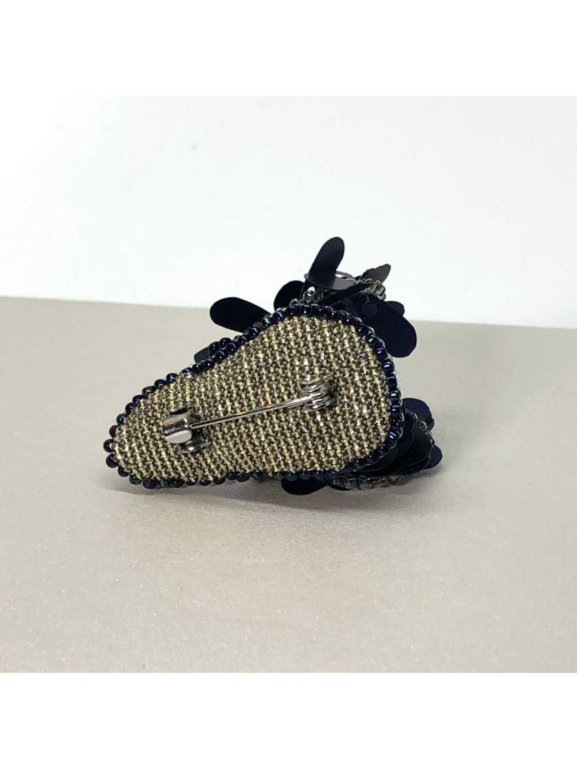 Navy blue bug brooch with wings.