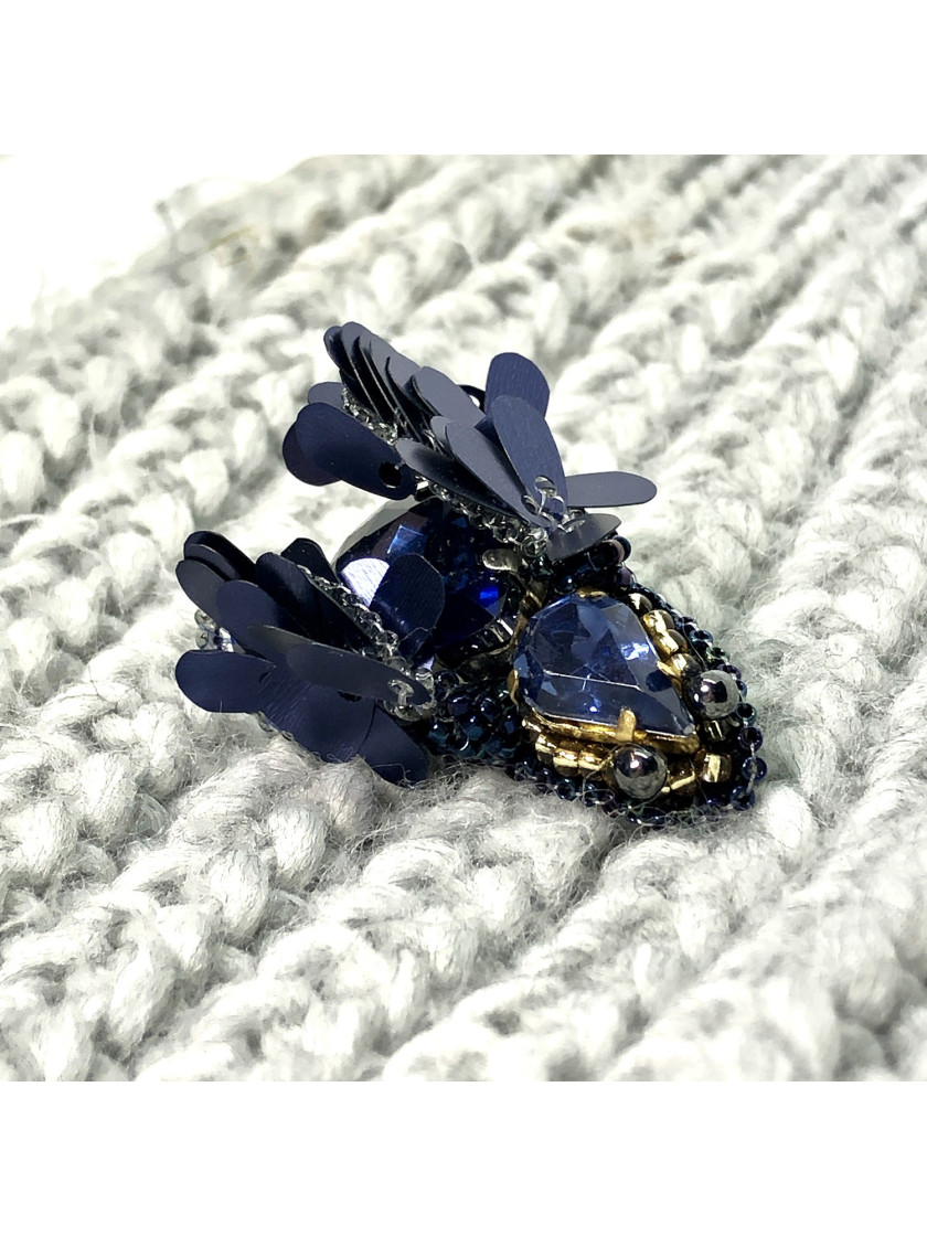 Navy blue bug brooch with wings.