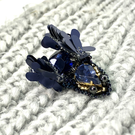 Navy blue bug brooch with wings.