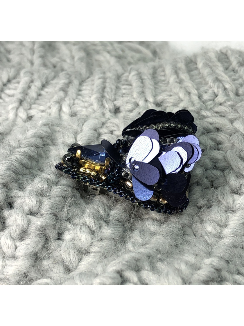 Navy blue bug brooch with wings.