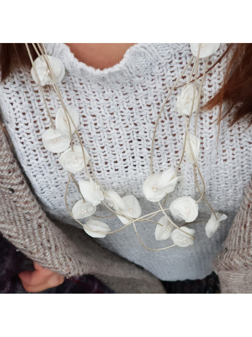 Delicate light and elegant long necklace with sewn flowers.